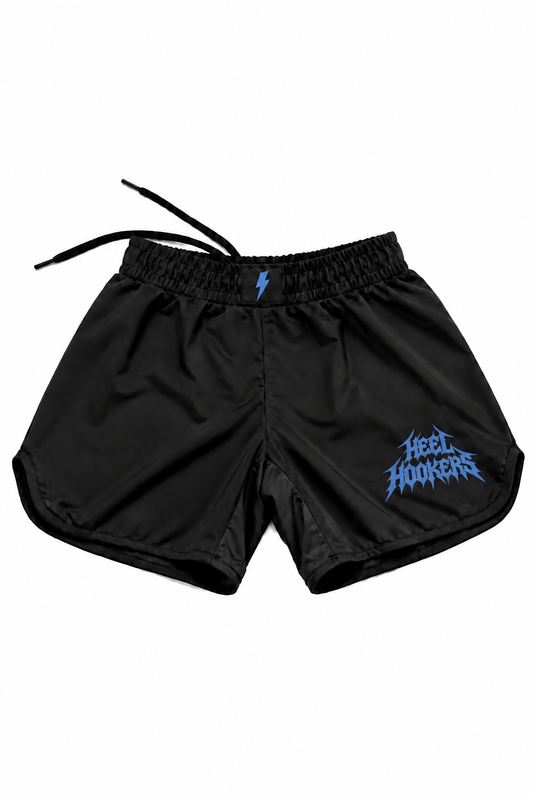 Concept mockup of black Heel Hookers fight shorts with flat blue metal-style lettering and blue waistband bolt